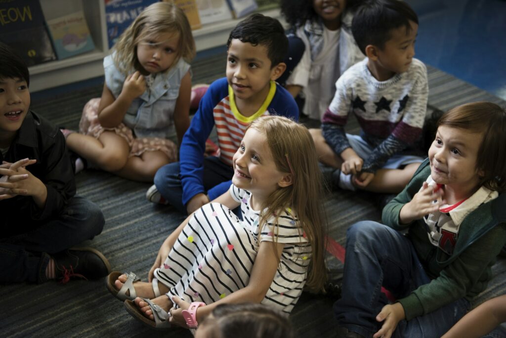 Kindergarten students sitting on the floor