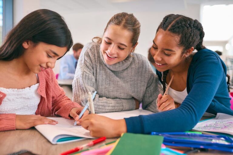 Three Female Secondary Or High School Students Collaborating In Study Area